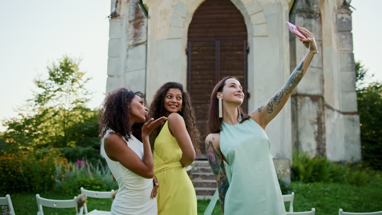 Three women taking a selfie at a wedding