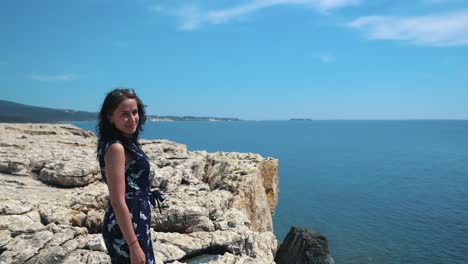 girl on a cliff overlooking the ocean