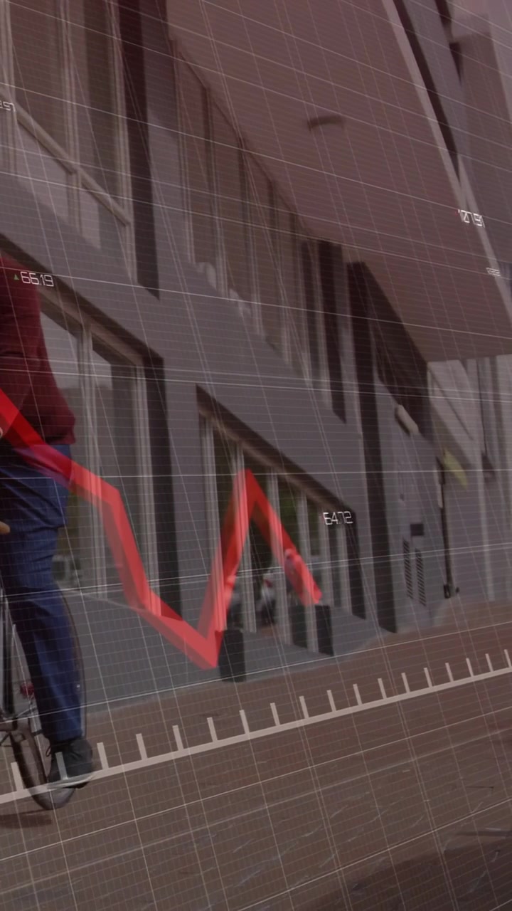 Vertical video: Man riding bike commuting by facade data overlay sparking finance red graph falling