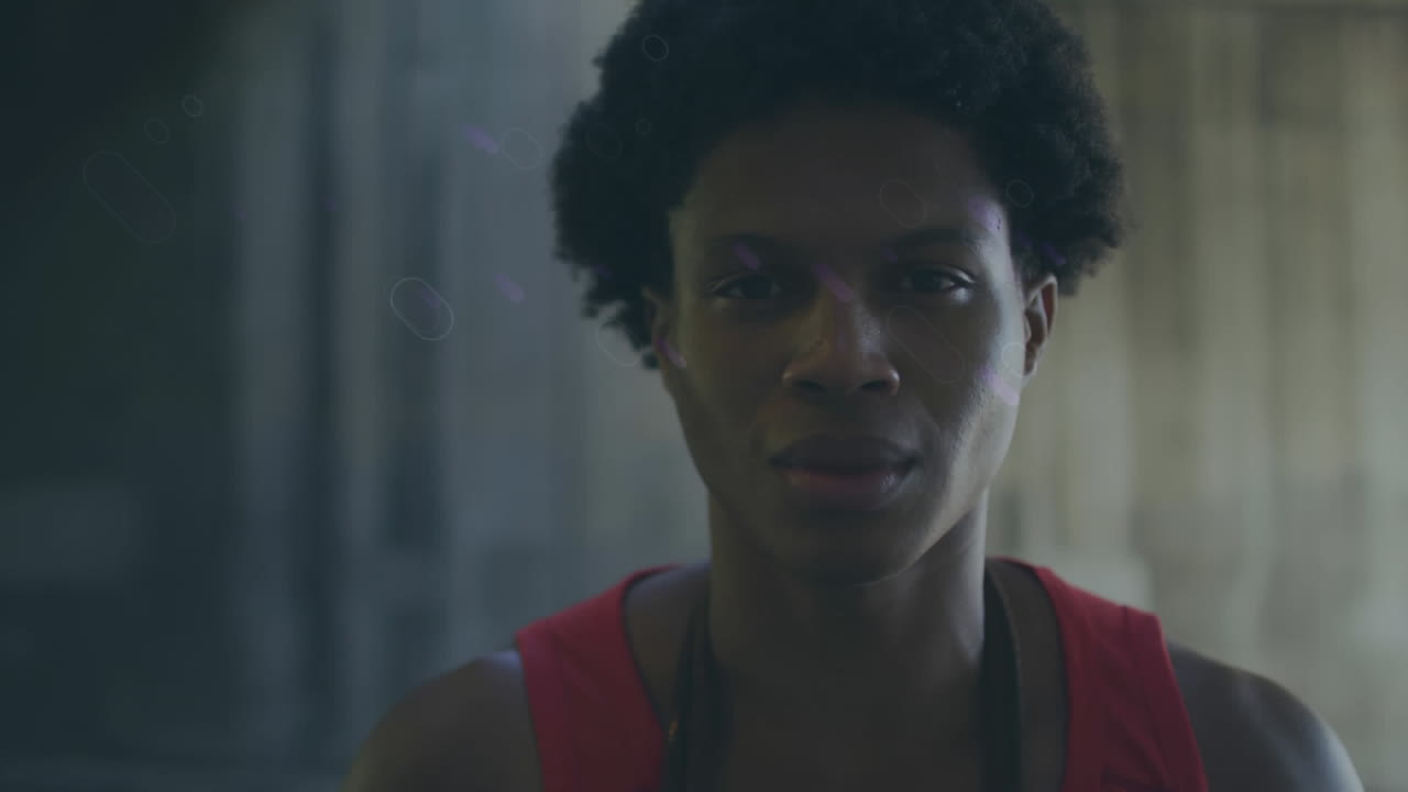 Animation of blue trails over smiling biracial sportsman