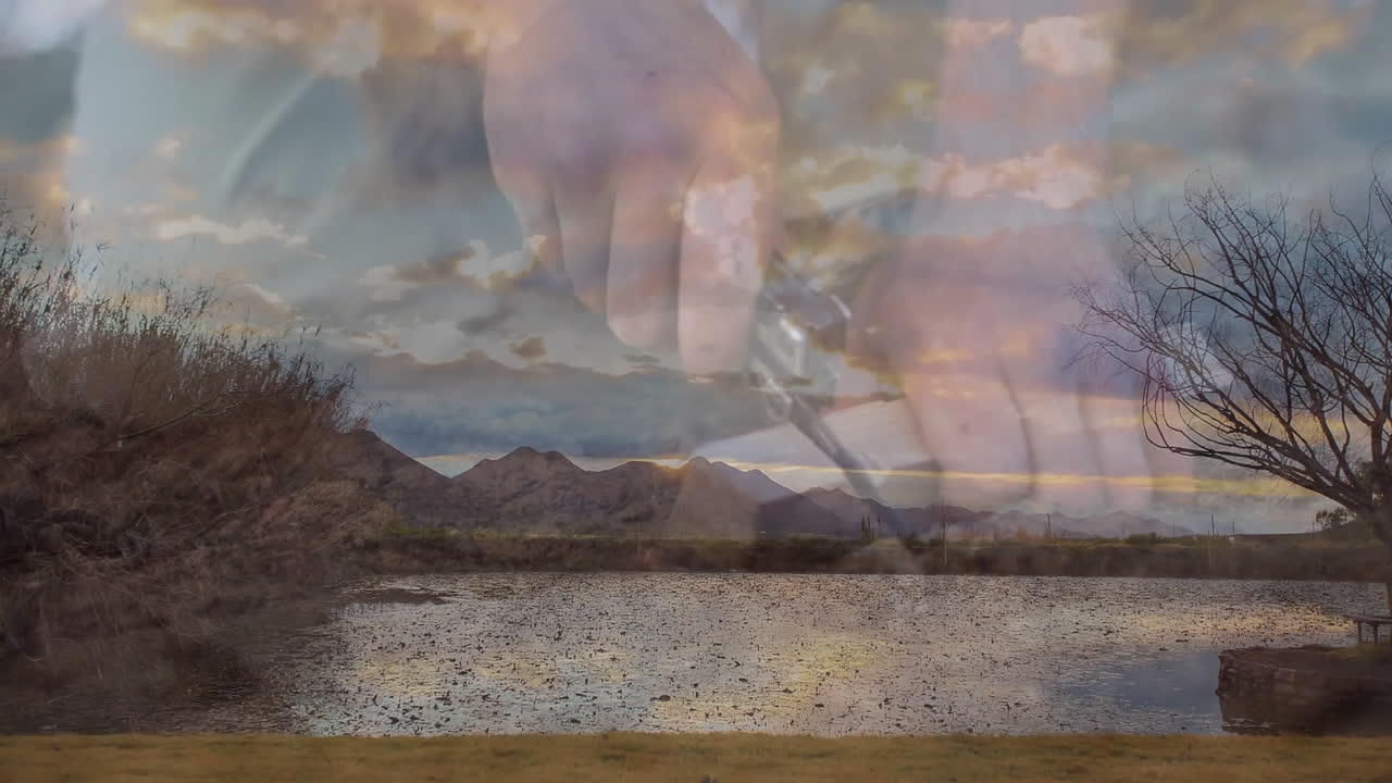 man's hands unfolding multitool knife over desert pond, displaying gear marketing concept