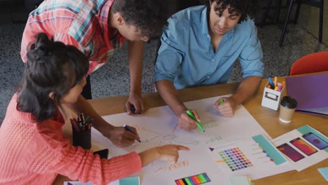 Happy-diverse-business-people-discussing-work-during-meeting-at-office