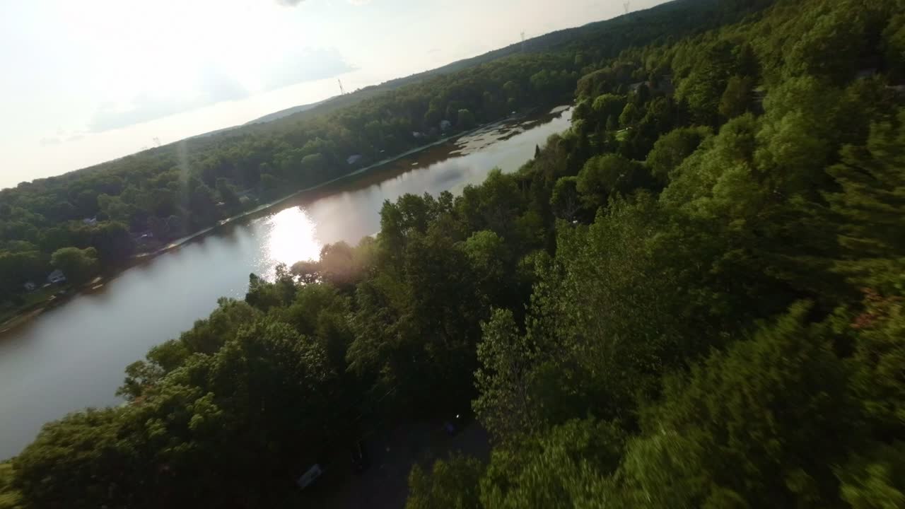 Aerial View of a Serene Lake and Cottage in the Woods