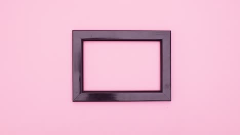 make up cosmetics products appear around black frame for text on pink theme. stop motion
