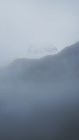 minimal misty blue mountain background with copy space for text, minimalist blue mist and fog with mountains vertical video for social media instagram reels and tiktok