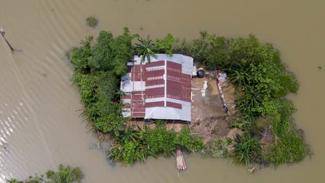 above view of house roof in a flooded village in bangladesh, south asia. aerial topdown shot