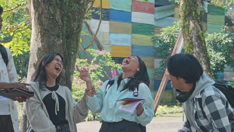 group of multiracial asian university best friends laughing together outdoor
