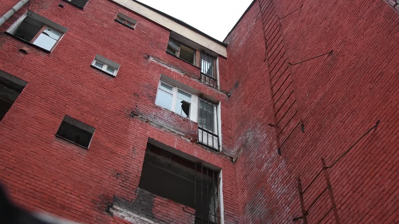 Slide camera Low-angle shot of old deserted Soviet building and broken windows