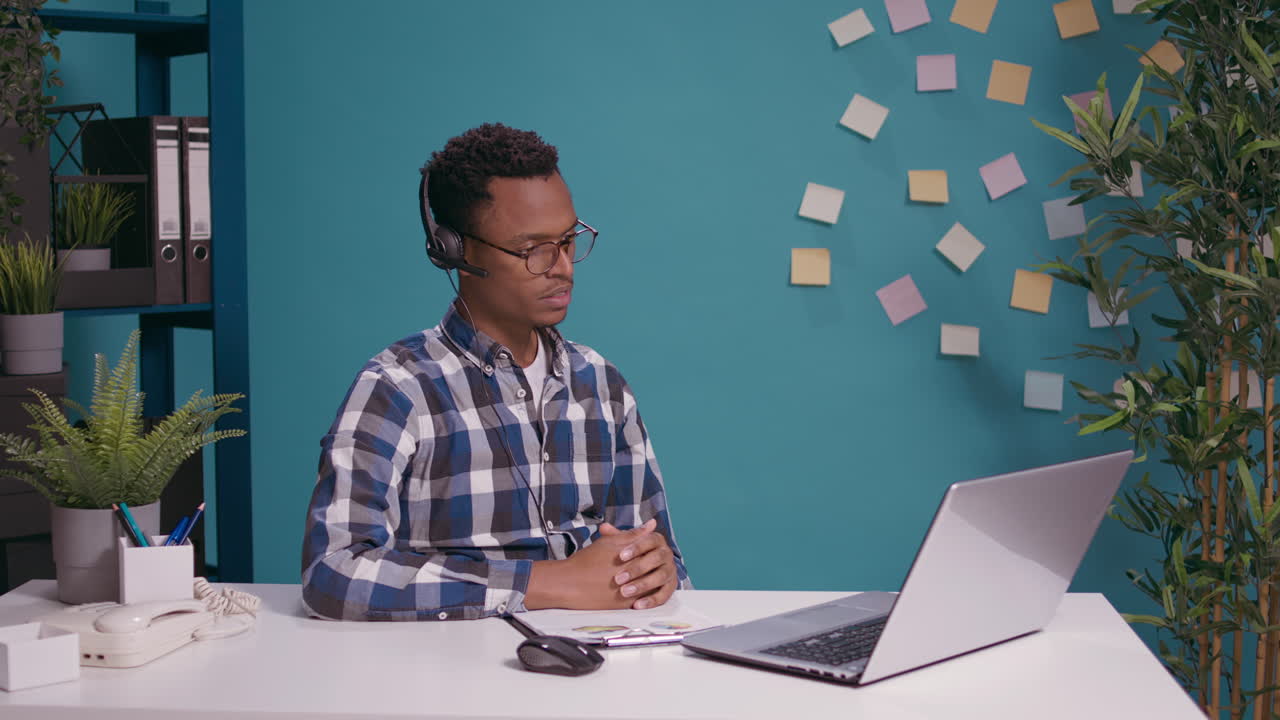 Call center worker talking to client on headset with microphone