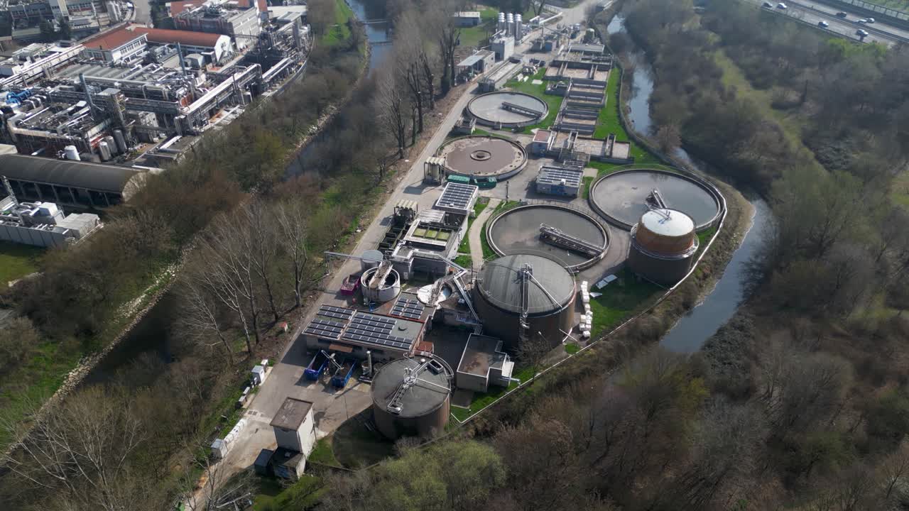 Aerial drone view of environmental technology facility in Milan, Italy. Water treatment systems operate within modern infrastructure to support sustainability, waste reduction and energy generation