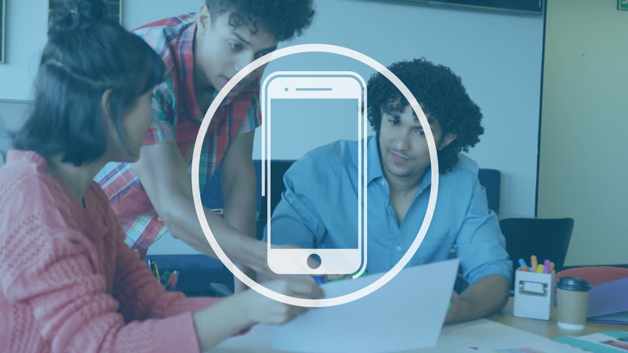 Young professionals collaborating at office with smartphone icon overlay animation