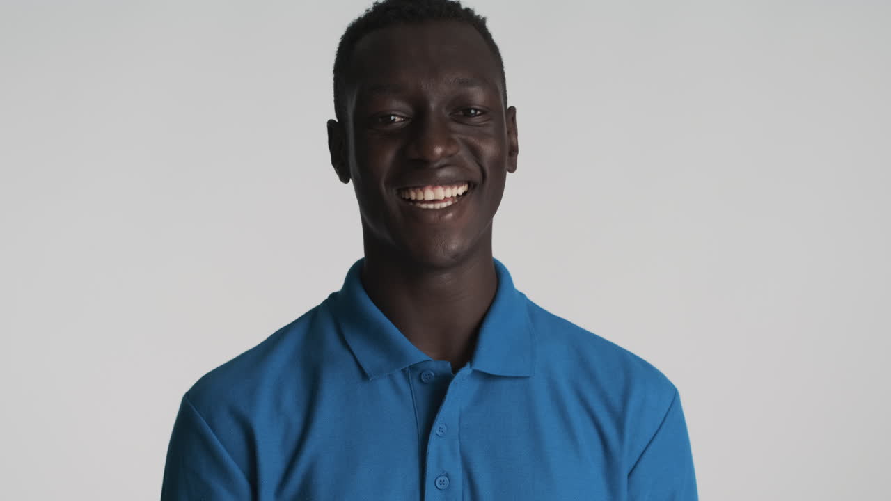Happy African american man on grey background.