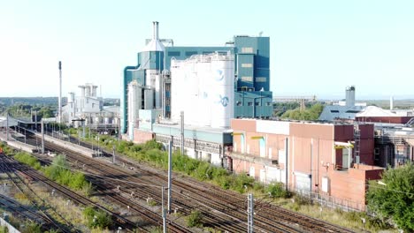 Industrial-chemical-manufacturing-factory-next-to-Warrington-Bank-Quay-train-tracks-descending-aerial-view
