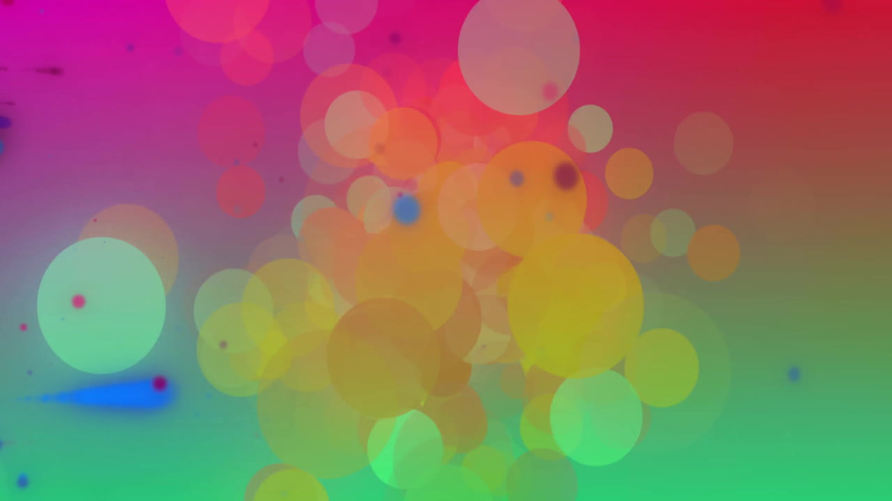 Animation of colourful light spots moving over soft pink and green background