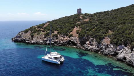 anchored ship in paradise close to rocks