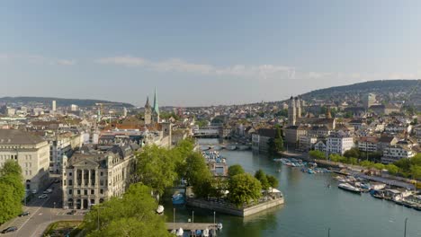 descending aerial shot of zurich old town next to lemmat river