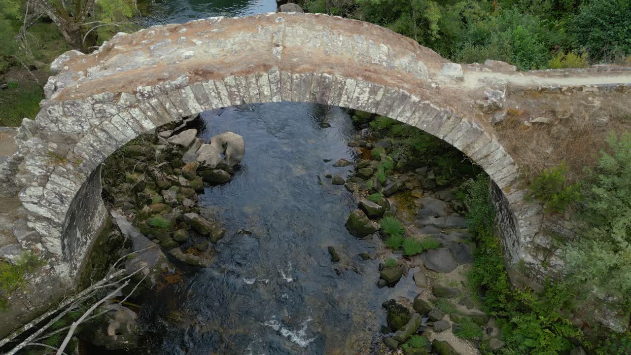 Abandoned Arch Bridge Over The Avia River Near The Town Of Cenlle, Ourense Province, Spain. Aerial Descending Shot