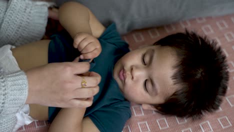 The-tender-moment-of-an-18-month-old-baby-boy's-nappy-change,-captured-in-slow-motion,-highlights-the-concept-of-gentle-and-nurturing-baby-care