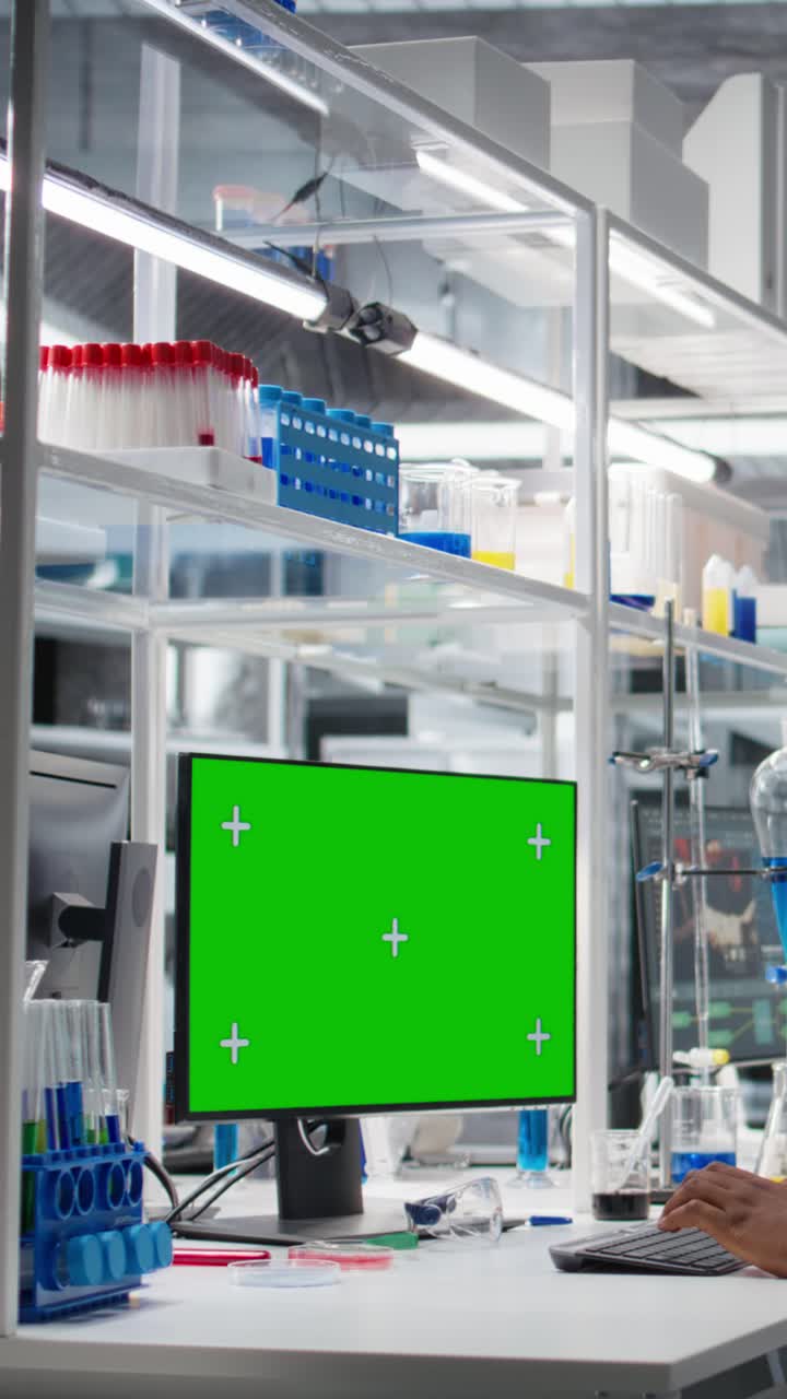 Vertical video Senior researcher working on isolated screen PC in lab, studying genomics