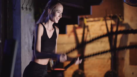 Attractive-Young-Fit-Female-Athlete-Exercising-With-Battle-Ropes-During-Cross-Training-2