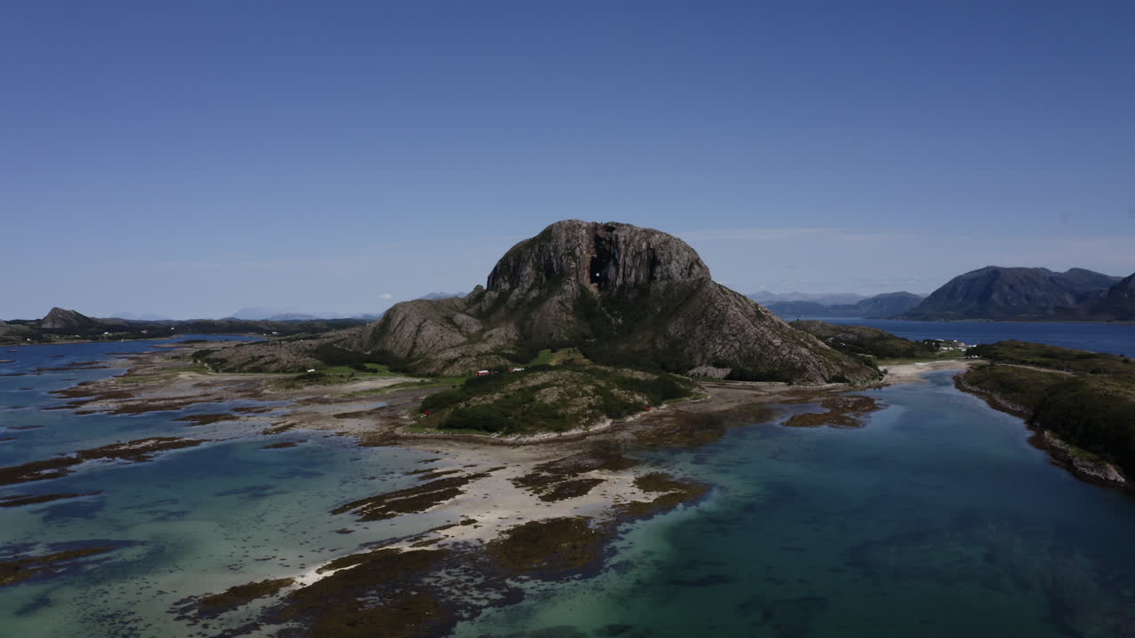 An aerial drone shot of Torghatten mountain, a mountain on Norway’s Helgeland coast with a hole right through the middle. Brønnøysund, Norway