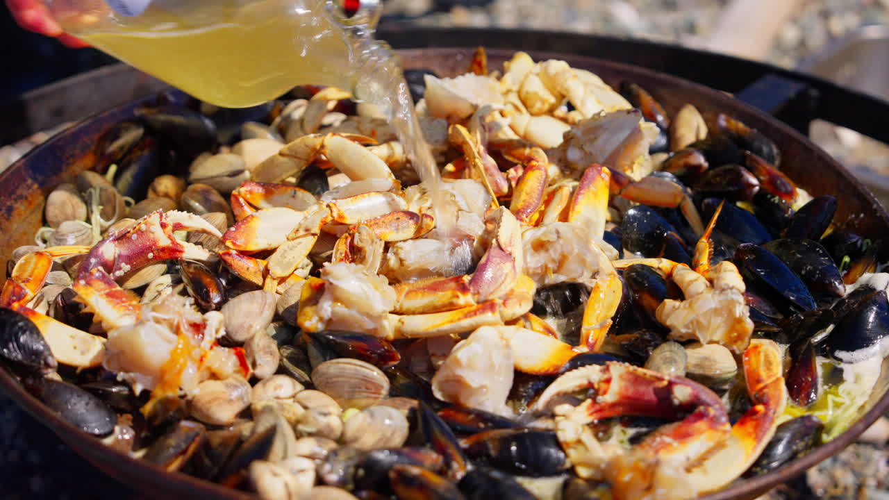 Vinegar poured over mixed seafood before cooking, highlighting the marination process and fresh ingredients in preparation. Ideal for culinary and food-prep footage