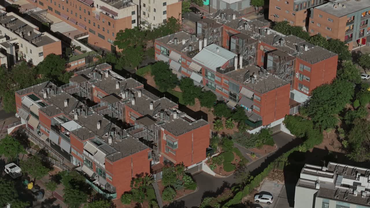 Orbit aerial of dense Soliva Este residential district with brick housing blocks, Málaga, Spain