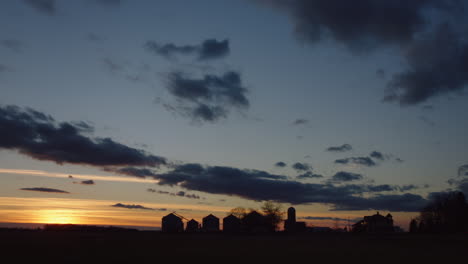 farm silo at sunset in rural america, time-lapse