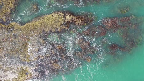 aerial view of coastal rocks and turquoise water
