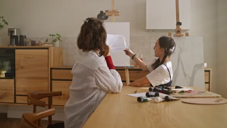 teenage girls painting together at home