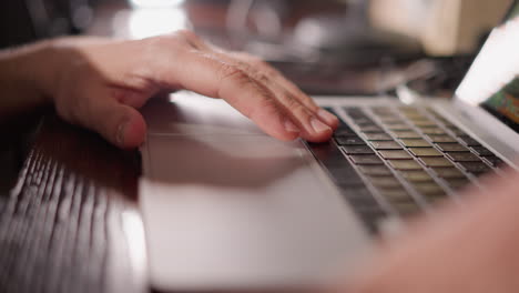 close-up of a hand resting on a computer keyboard, with a blurred background that hints at a focused and productive workspace