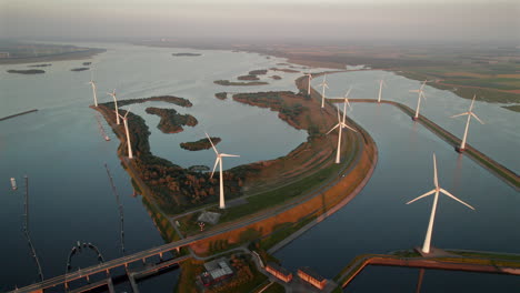 rotating wind turbines of windpark krammer at krammersluizen water works during sunset in bruinisse, netherlands. aerial drone shot