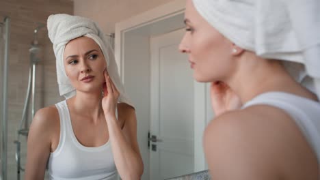 caucasian woman  in the bathroom having a strong toothache or bruxism.