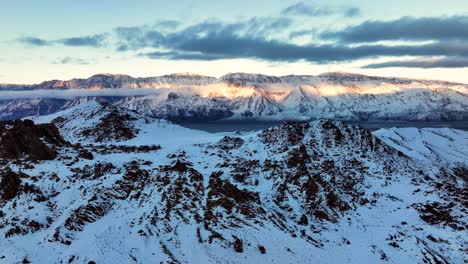 Slow-cinematic-tilt-of-the-snow-covered-Alabama-Hills,-California