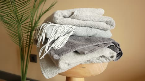 stack of folded towels on a wooden stand