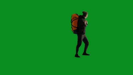 hiker with backpack and camera on green screen