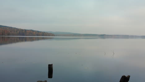 moving over a calm lake in the autumn
