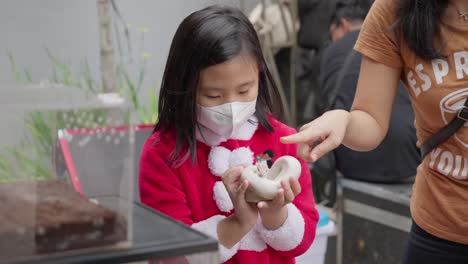 girl holding a pet snake