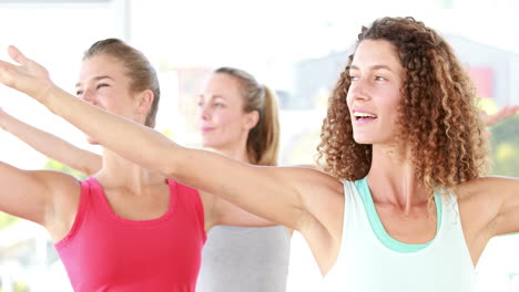 smiling athletic women standing in yoga position