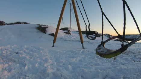 4k close-up of a swing on a playground on a cold winter day in sweden