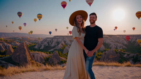 romantic couple amidst hot air balloons in cappadocia at sunrise