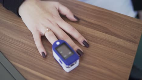 pulse oximeter, placed on finger during office examination, registers vitals