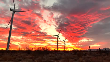 wind turbines in californian desert turning at sunset, dramatic skyscape view