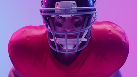 Video-of-caucasian-american-football-player-in-helmet-over-neon-purple-background