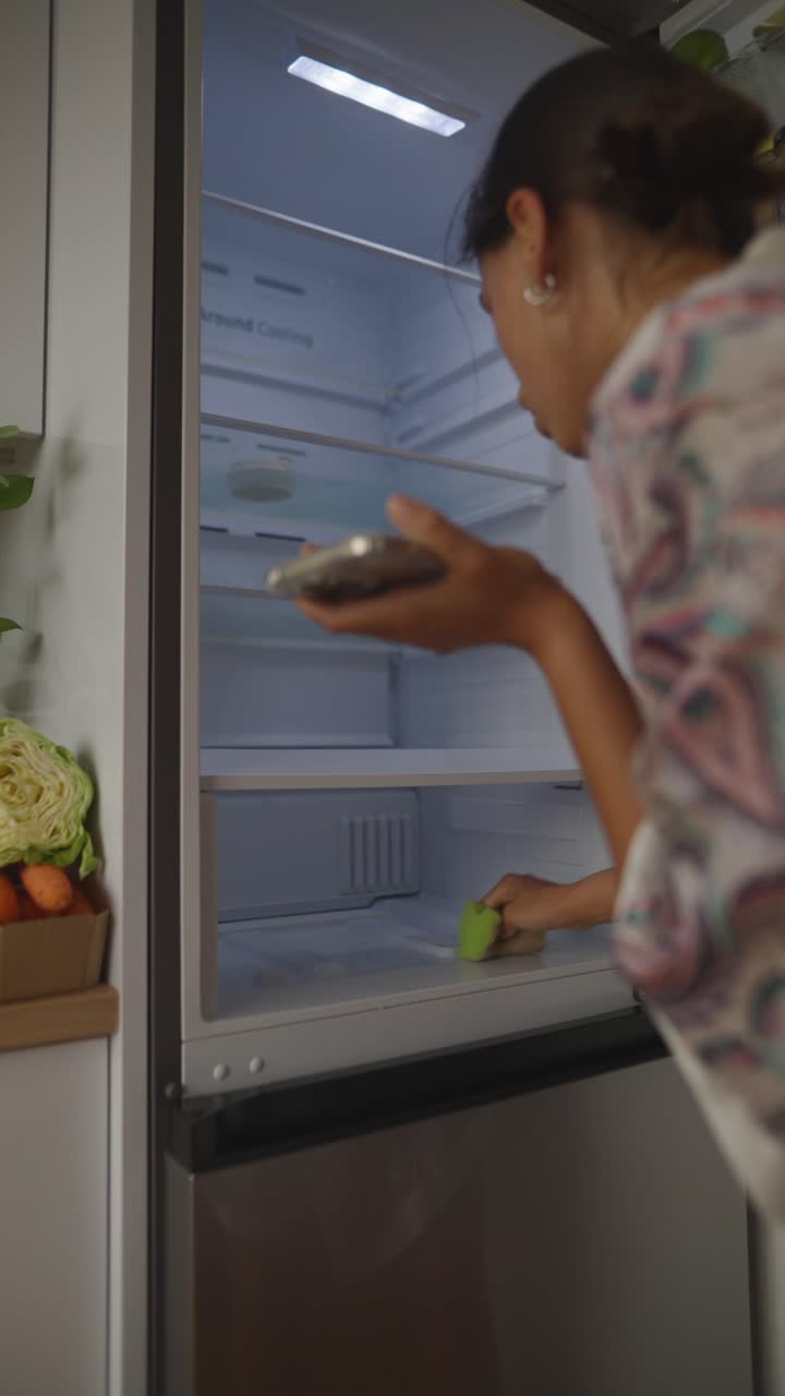 Woman Cleaning Inside a Refrigerator