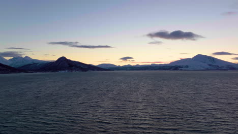 Beautiful-sunset-silhouetting-a-mountain-range-and-the-sea-in-Norway