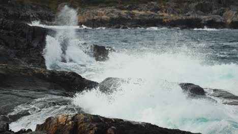 the coastline along the atlantic road is filled with jagged rocks and turbulent ocean waves crashing ashore