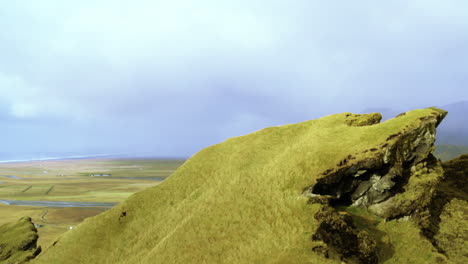 reaching top of the mountain. aerial view on mountains peak, natural path, mountain with plants, vegetation, sky with clouds background. stunning shot of green hills and breathtaking mountains