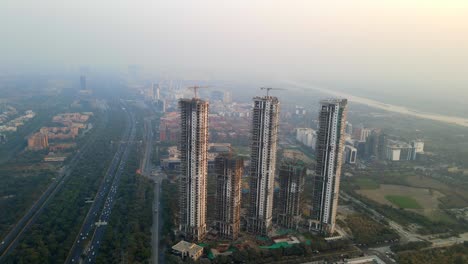 aerial drone shot capturing a massive high rise construction site in noida india