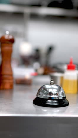 restaurant service bell with blue gloves